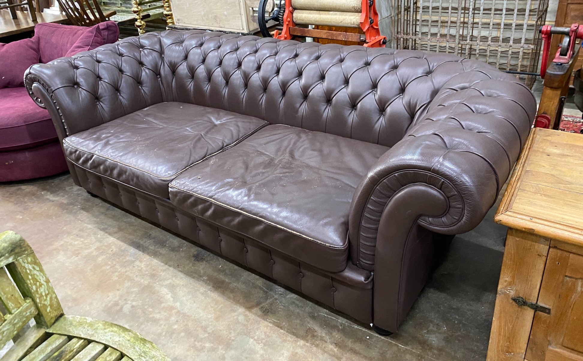 A Heals buttoned brown leather Chesterfield settee, length 234cm, depth 100cm, height 76cm